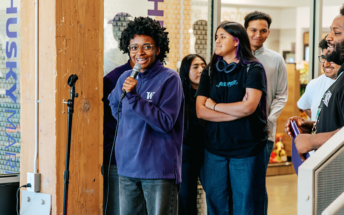 UW Tacoma student Nevaeh Wright speaks into a microphone during a new student orientation on campus.