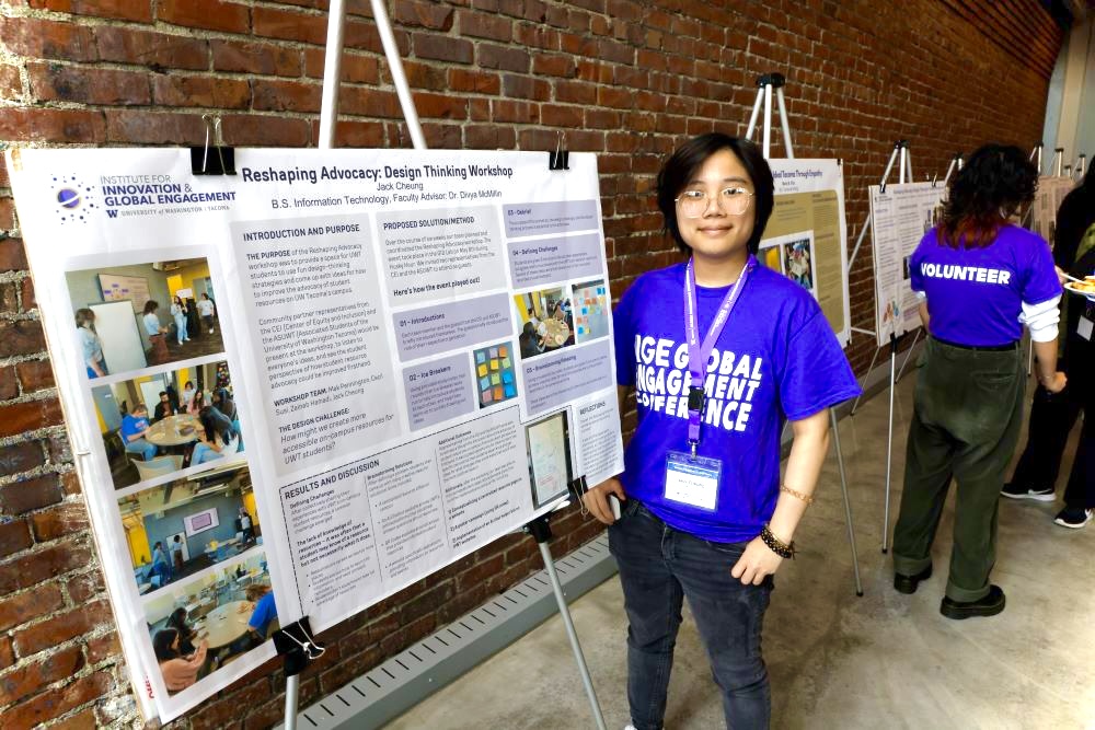A student named Jack standing alongside his poster presentation at the Global Engagement Conference