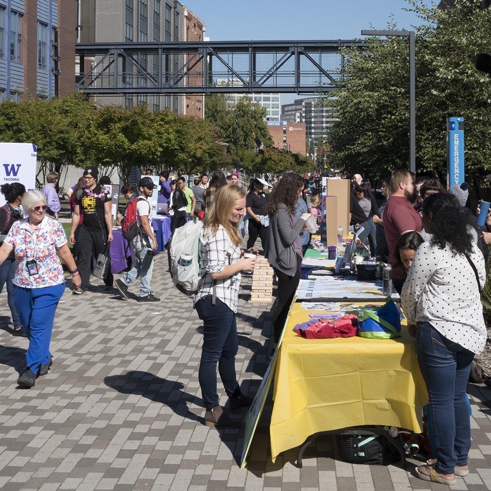 a student at a fair at UW tacoma at a booth