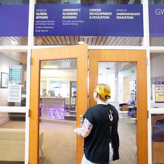 A student going to the entrance of the University Advising Center