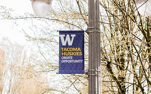 Photo of banner on lamppost that says Tacoma Huskies Create Opportunity