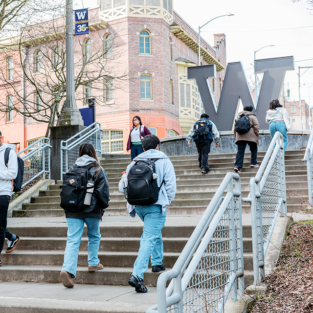 people walking up outdoor staircase