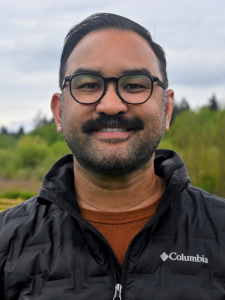 Headshot of Christian James with a nature background