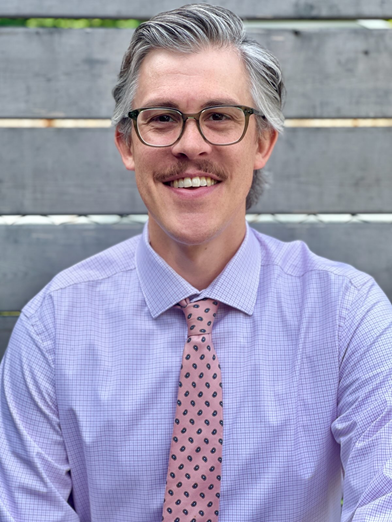 Photo of David Hopkins in front of outdoor stairs