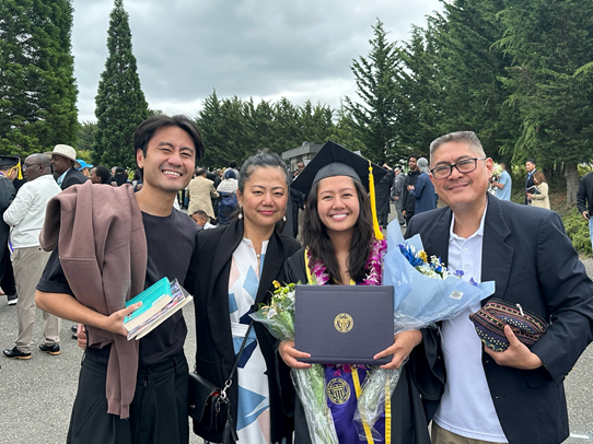 Photo of Jayana Estacio and her family taking a photo after graduation. From left to right, Jayana's brother, Ms. Estacio, Jayana, and Mr. Estacio.