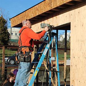 Dan Smith of Clover Park Technical College building the SHED at UW Tacoma Giving Garden