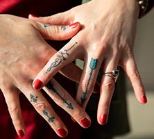 Tattoos on Dr. Alex Nutter's fingers.