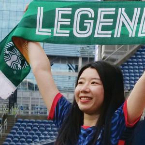 Luna Zhang holding up the Starbucks Legend Scarf Banner