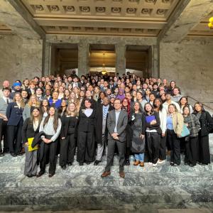 Students from all three University of Washington campuses standing with Washington Governor Bob Ferguson
