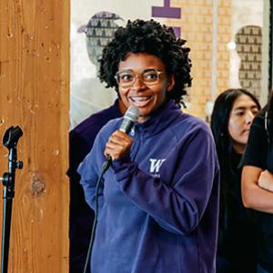 UW Tacoma student Nevaeh Wright speaks into a microphone during a new student orientation on campus.