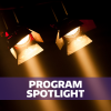 Text "Program Spotlight" over photo of theater spotlights