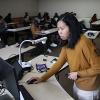 Associate Teaching Professor Rita Than uses a desktop computer in a classroom on UW Tacoma's campus.