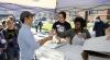 student workers giving out cupcakes on W day