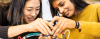Two women students working on wiring a circuit board
