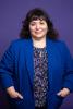 Director Susan Wagshul-Golden pictured from the waist up in front of a purple background