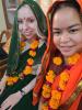 Two students dressed in traditional clothing with flower garlands around their neck
