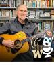 Dr. Michael Honey playing the guitar in his UW Tacoma campus office