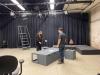 Two AMC students preparing a stage in a studio