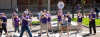 Photo of people playing band instruments on campus