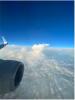 view of the sky above the clouds from an airplane