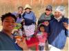 group selfie of a student in scrubs with villagers