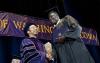 UW Tacoma graduate shaking hands of Vice Chancellor JW Harrington at  2013 Commencement
