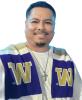 Kiko Salas has a UW scarf on and stands in front of a white background.