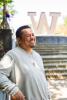 Kiko Salas stands on a staircase in front of a giant W