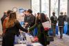 Milgard Student at the 2025 Business Career Fair shaking hands with a potential employer