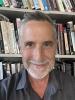 Headshot of Yonn Dierwechter with bookshelf behind him