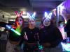 Three students in makeup and glowing bunny ears smile or otherwise pose for the camera.