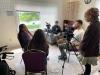 a photo of somebody being interviewed in a house by students