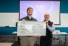 Evan Garner and David Borough-Kim pose with the giant check for winning the UWT Investment Challenge