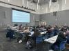 Presenter in front of large classroom with students