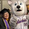 Graduate celebrating with Hendrix at Grad Fair