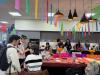 Students around kitchen table celebrating the day of the dead. 