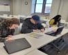 Three students working on classwork