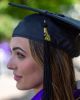 Sage Ahrens-Nichols poses for a graduation portrait with cap and tassel. 