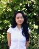 headshot of linda dang with greenery background
