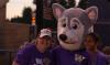 Hendrix the husky mascot with student and staff member